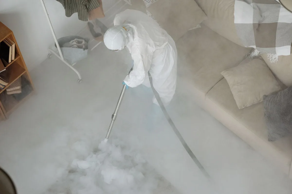 Biohazard cleanup technician in protective equipment, Woodland Park, CO